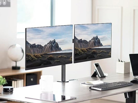 Ergonomic desk setup showing two monitors mounted on the Orgemy dual arm for a clean, minimal look.