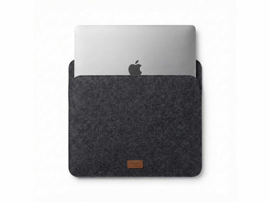 Orgemy grey felt laptop sleeve with MacBook inserted, showing snug fit.