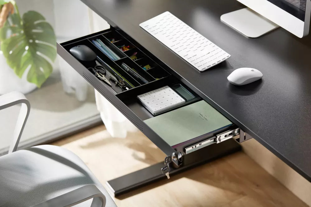 Open view of large metal drawer showing internal organizer tray for pens and open space for tablets.