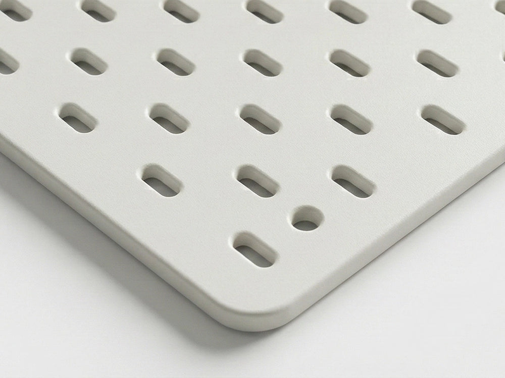 Close up view of Orgemy white modular pegboard panel 19x20 inches with vertical slots.