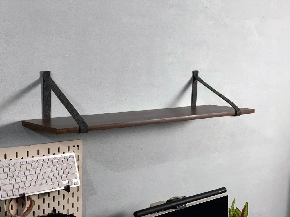 Side view of felt shelf holder showing minimalist mounting style.