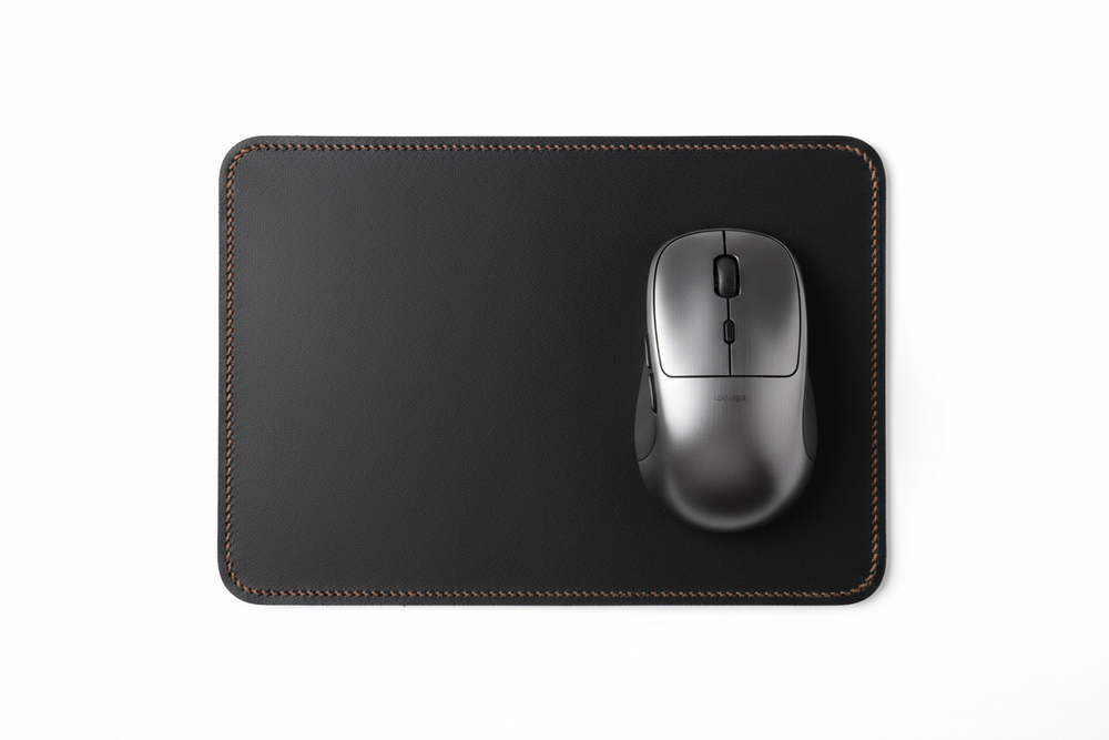 Orgemy full-grain leather mouse pad top-down view with mouse resting on midnight black surface
